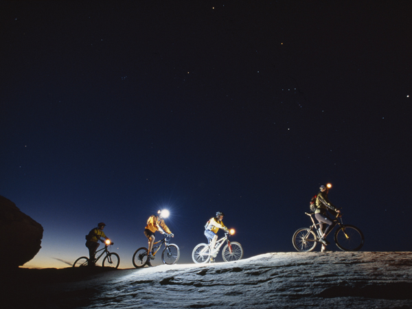 Mountain bikers finish up the 'slickrock trail' at dusk.